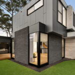 rear view of grey double storey modernist style home